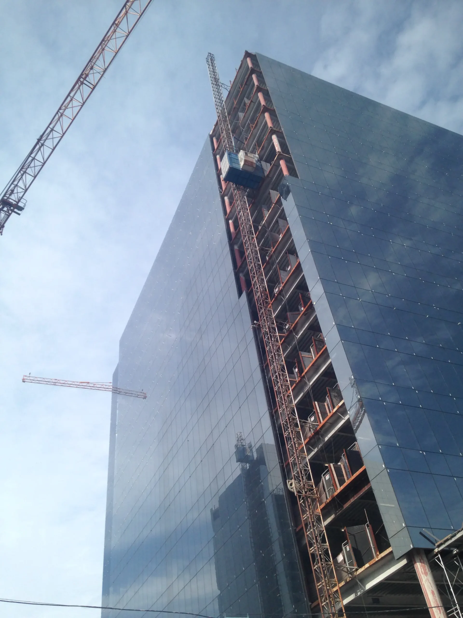 high-rise-construction-cranes-cloudy-sky